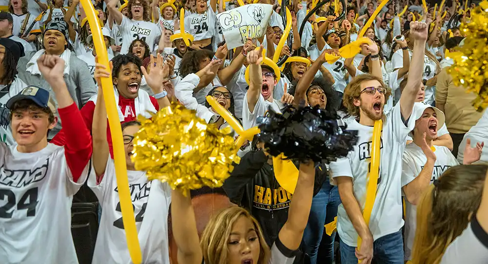 Photo of VCU students cheering and waving gold balloons